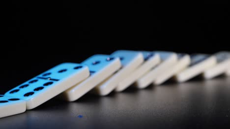 white domino dice fall on a black background