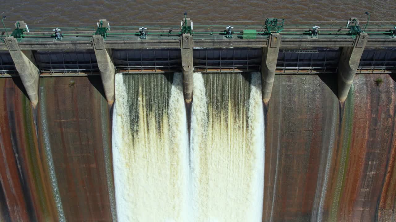 Close up and rising aerial footage of water being released from Lauriston Reservoir, in central Victoria. October 2022.