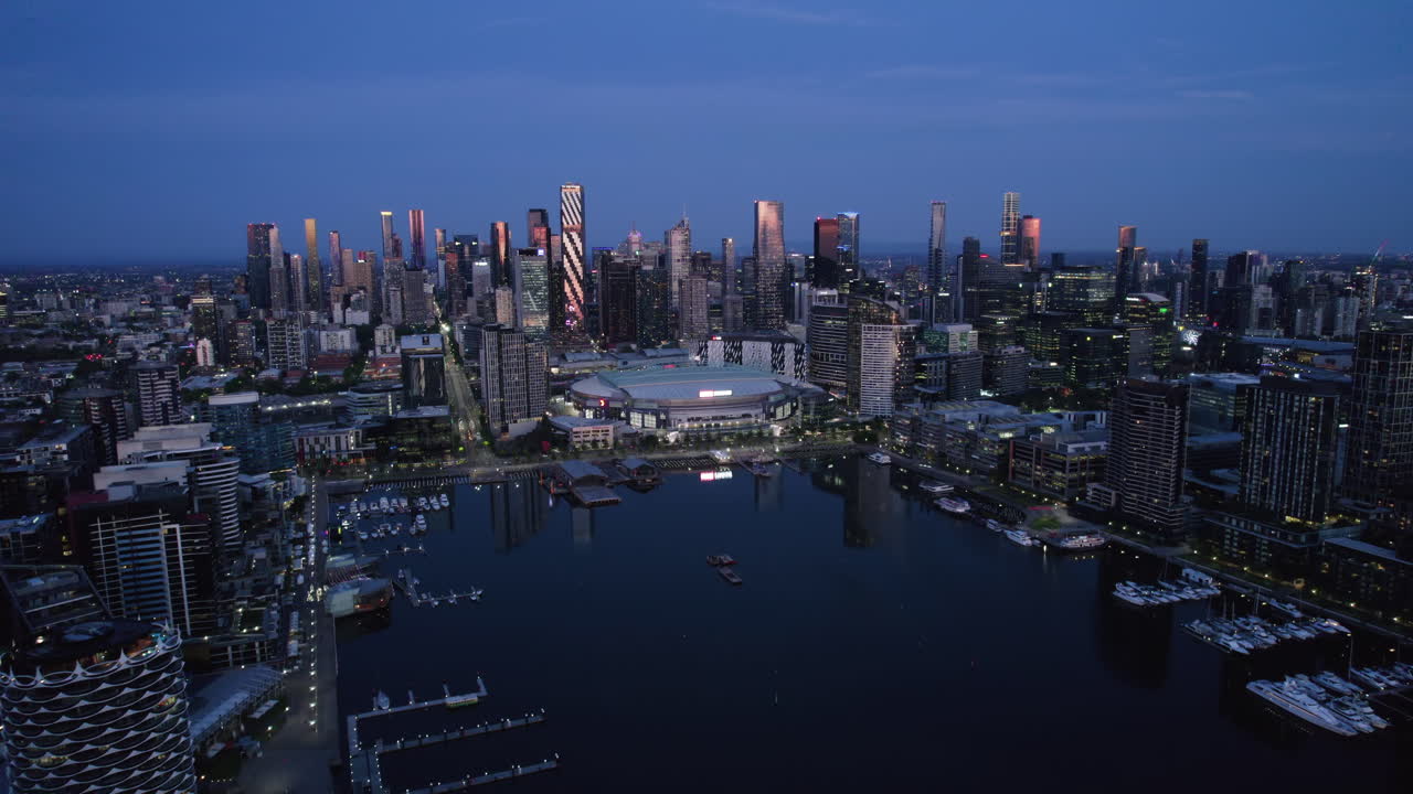 Aerial view Docklands, approaching Marvel Stadium at dusk, Melbourne