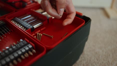 assorted tools and screws in a tool box