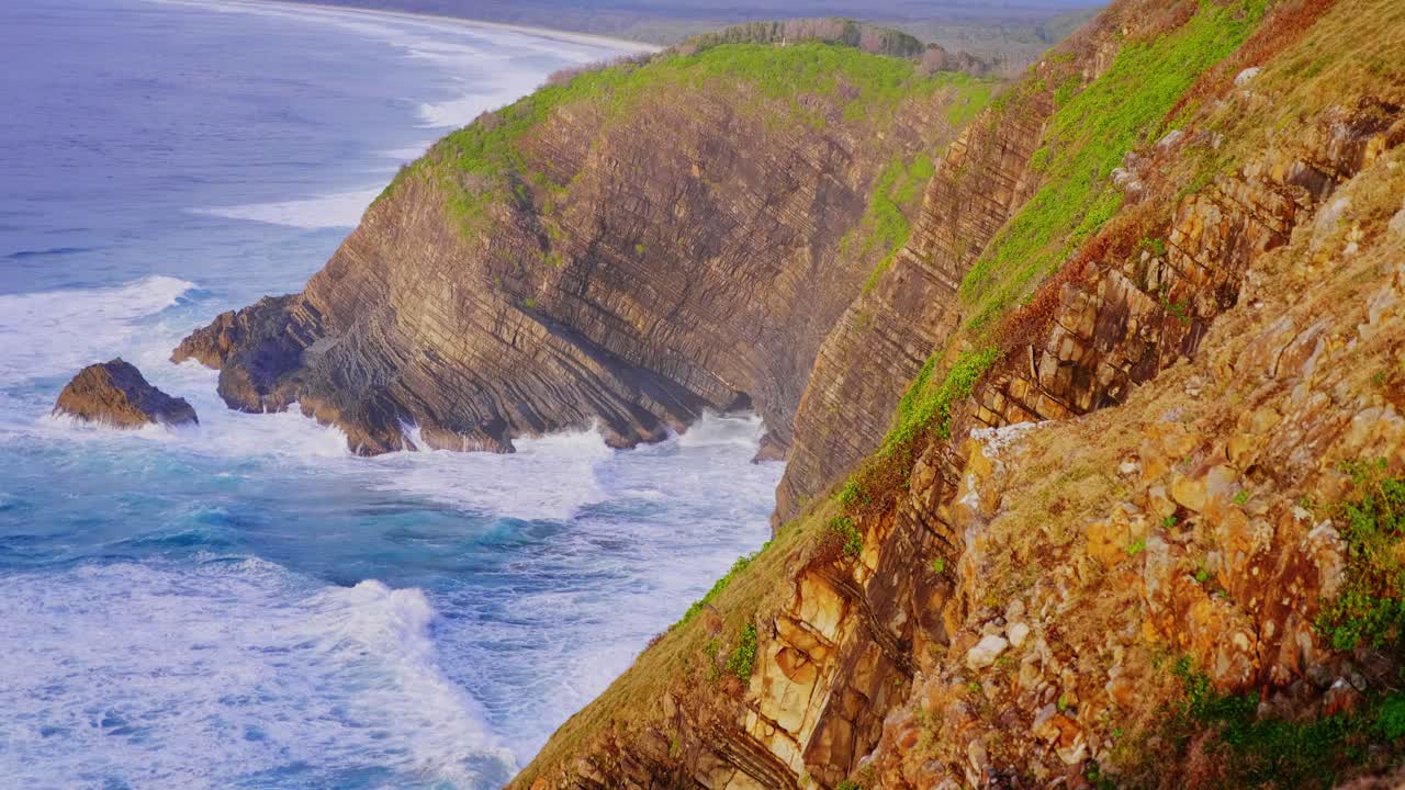Bright Blue Sea Waves Rolling To The Rocky Coast - Crescent Head Beach, NSW - Tourism Australia - high angle slowmo shot