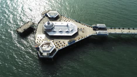 aerial view historic llandudno pier landmark tourist seaside promenade landmark rising tilt down above pavilions