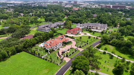 an aerial view of multiple mansions and estates, on a sunny day.