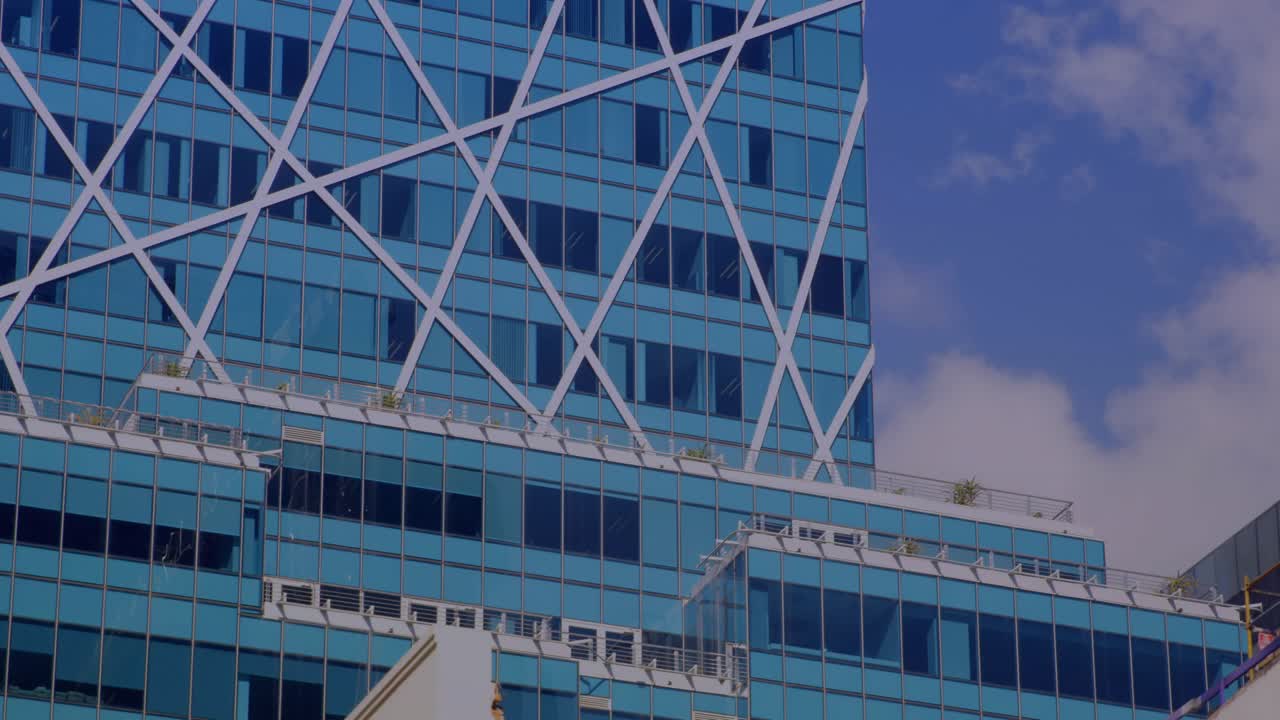 HUD overlay appearing on right, sliding and fading while blue glass tower staying left, showing map