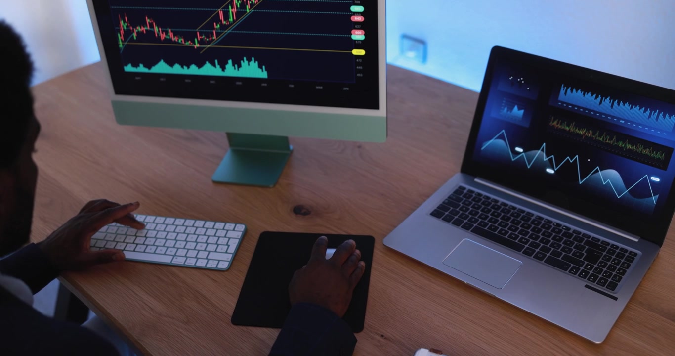 Financial Analyst Working on Stock Market Data at Desk