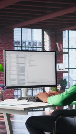 vertical video african american it expert working with a computer full of code