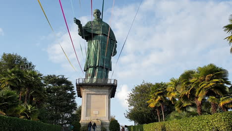 zoom out of giant statue of san carlo in arona, italy