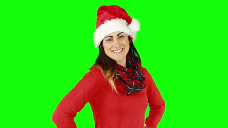 Festive-brunette-in-santa-hat-blowing-over-hands