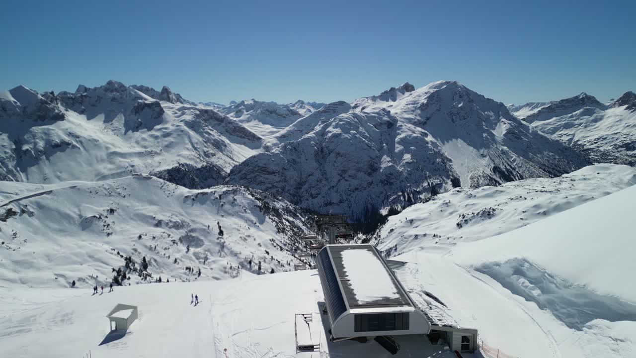 Epic drone footage of snow capped peaks in Austrian ski resort of Lech on a beautiful sunny clear blue day