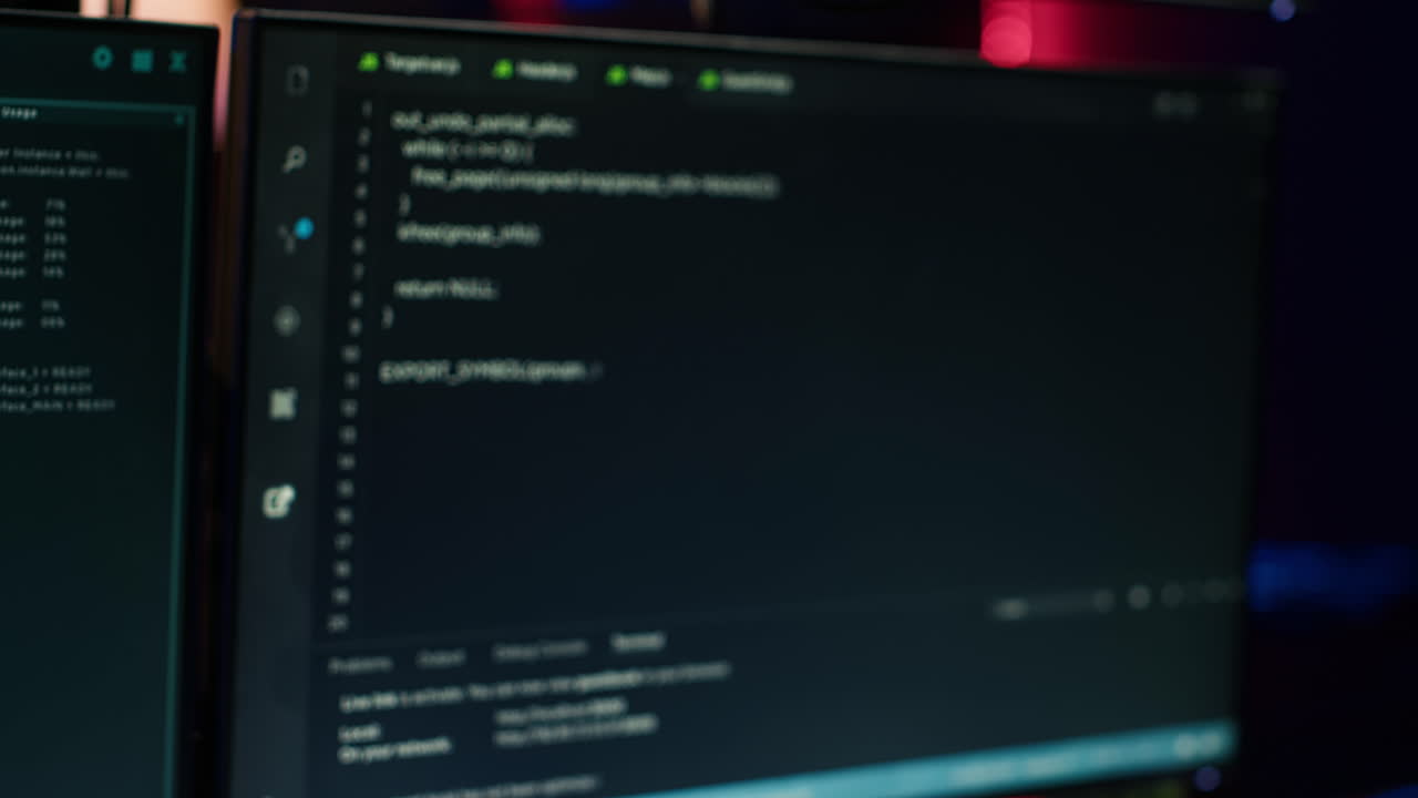 Extreme close up of software interface on PC screens showing lines of code