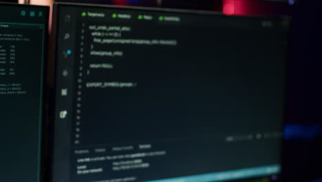extreme close up of software interface on pc screens showing lines of code