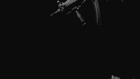 machineguns on the dark background and in blinking lights are falling in slowmotion