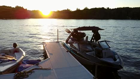 video walking along a dock past a boat towards a lake sunset