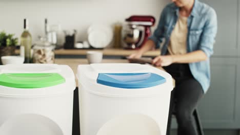 Woman-throwing-the-read-newspaper-into-the-appropriate-garbage-can