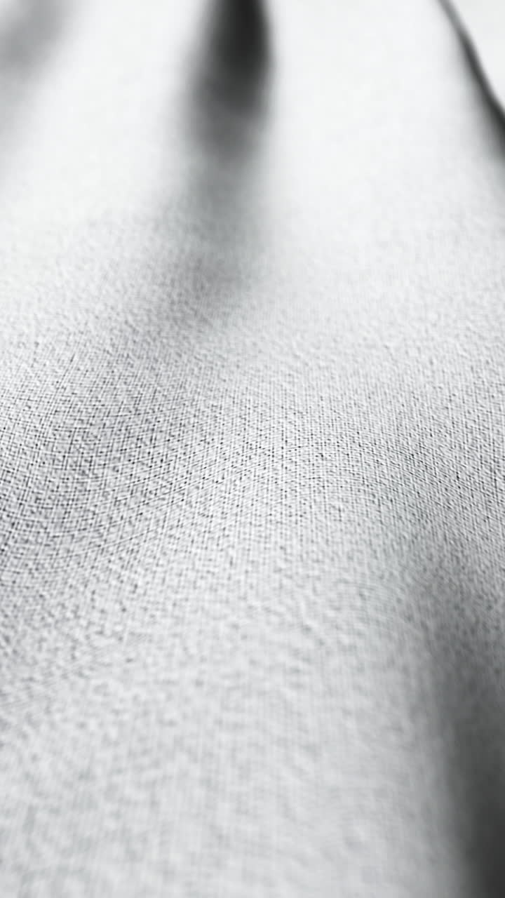 Fundo com textura de tecido cinza claro em movimento lento