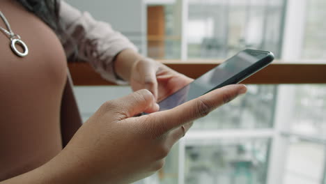 Hands-of-African-American-Businesswoman-Using-Smartphone