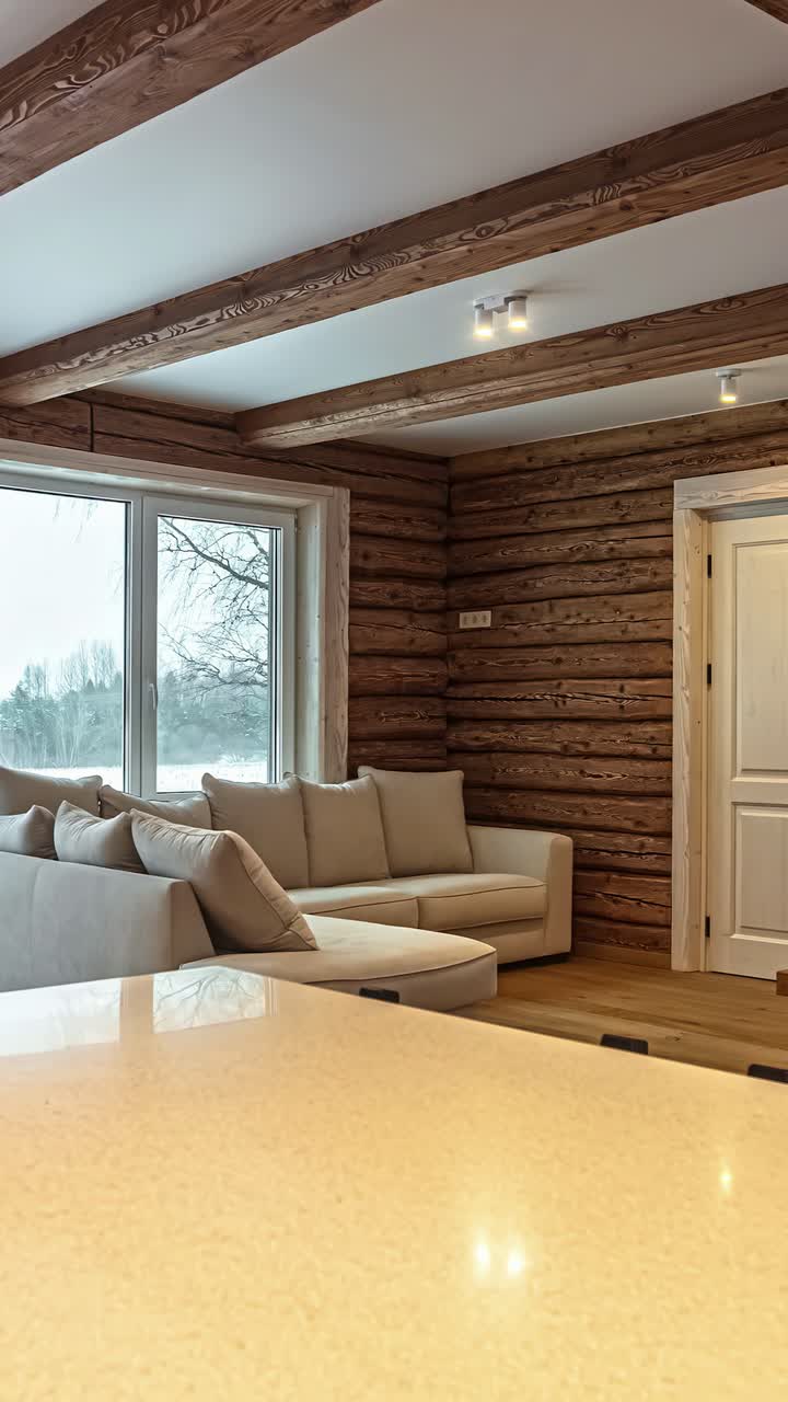 A panning shot reveals modern electrical outlets and a light switch installed on a wooden beam, showing the energy supply and convenience in a remote rustic log cabin