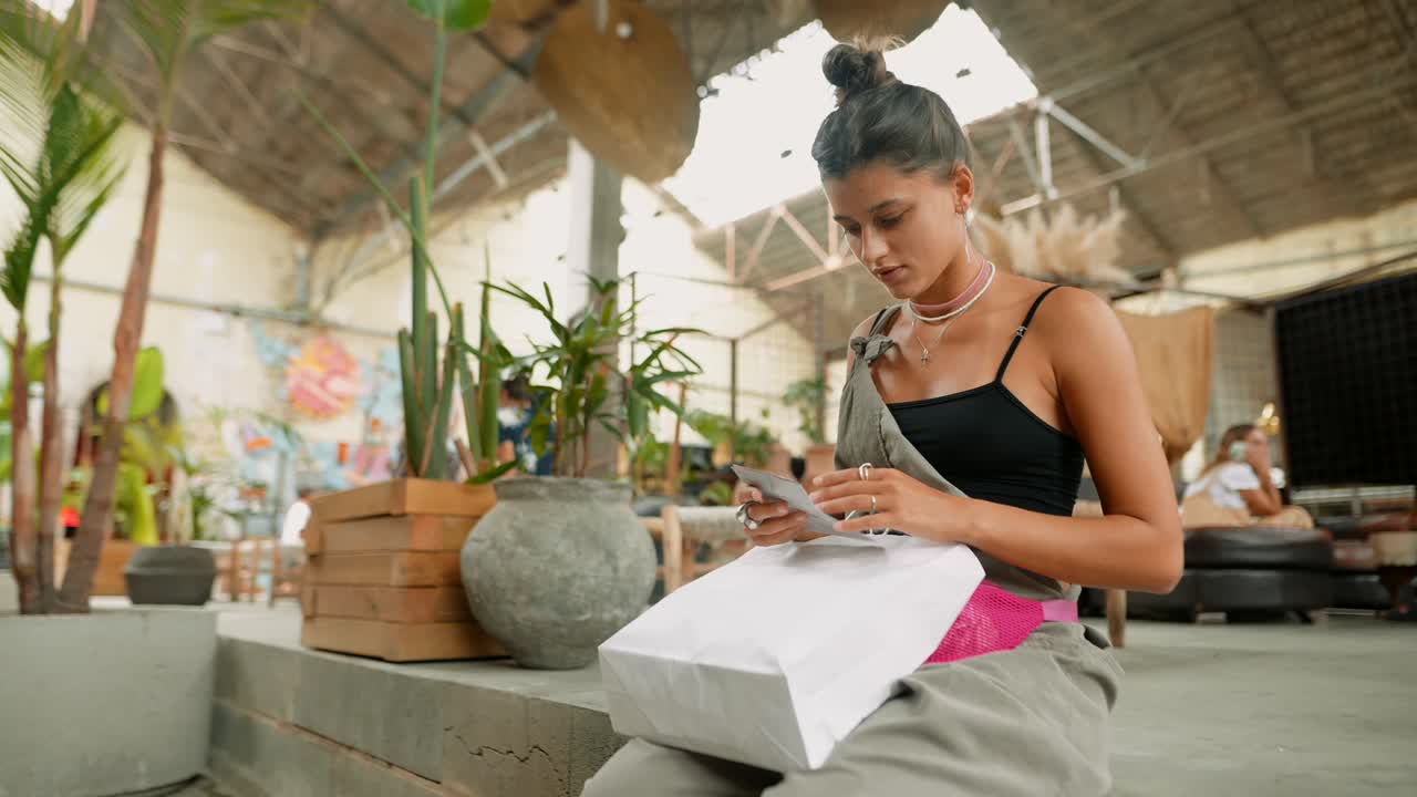 Woman with Shopping Bag in an Indoor Setting