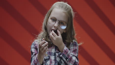 girl applying lipstick