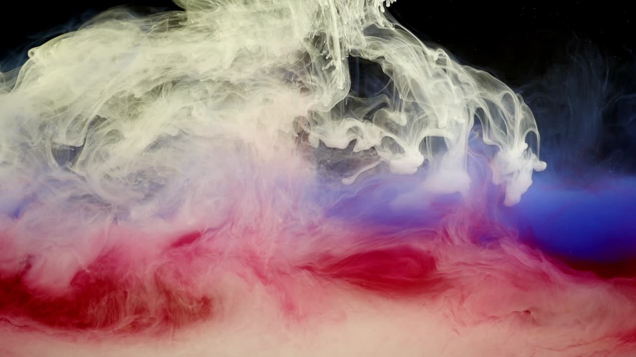 Abstract forms. Shooting on a black background. Mixing of paints