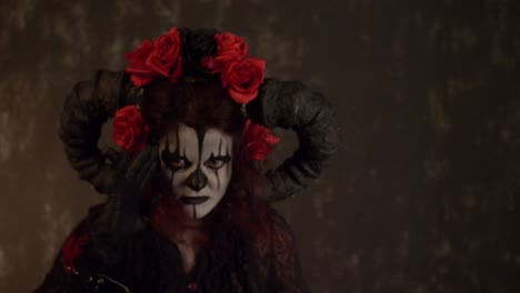 catrina cosplay girl moving her hands infront of her face with lustful face in a dark background, medium close up