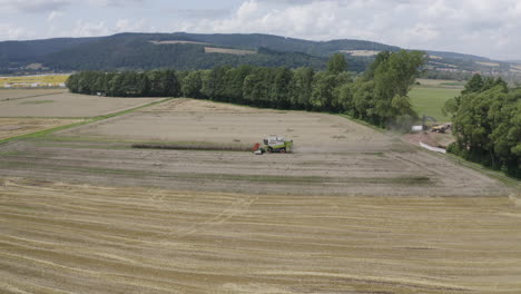 combine harvester working on a land of hay