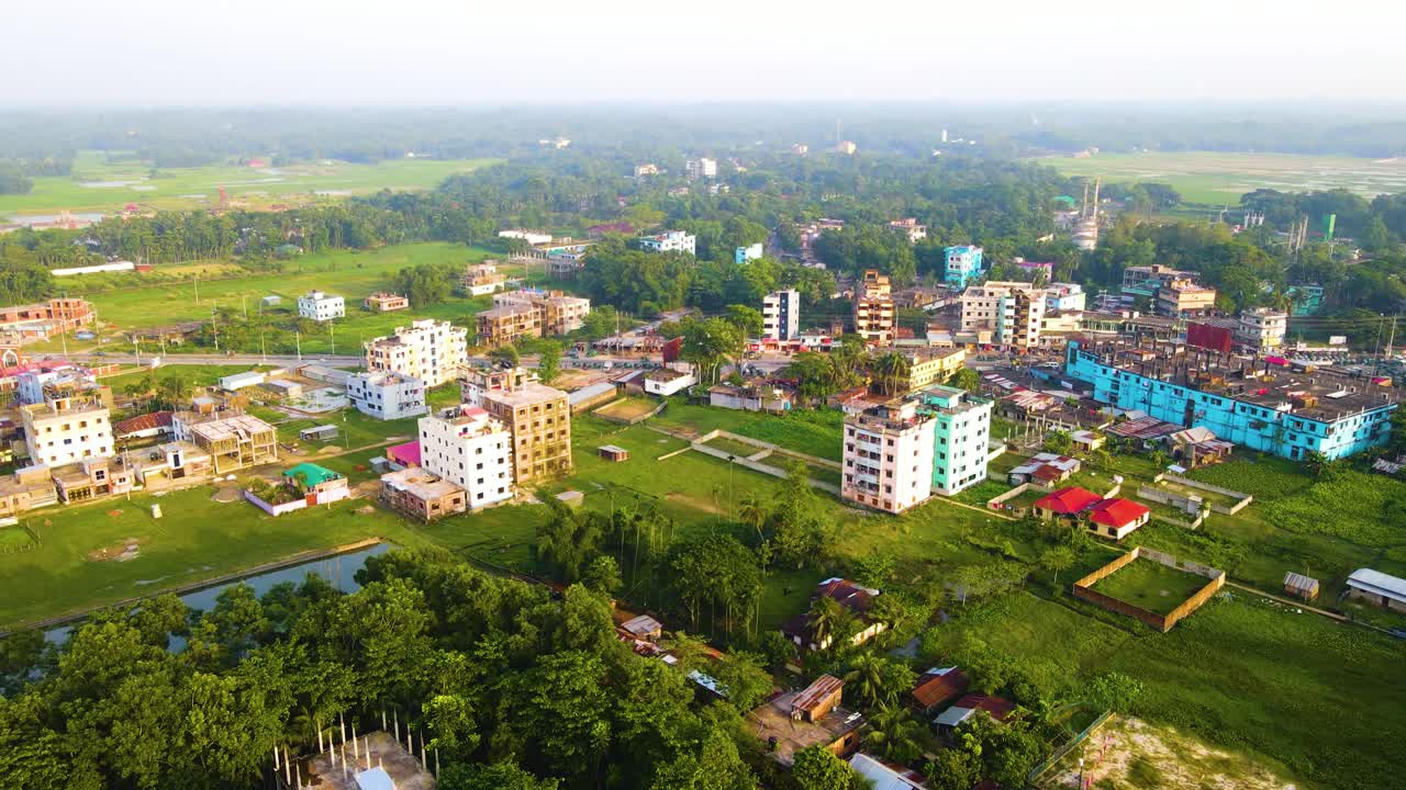Aerial view establishing colourful Bangladesh apartment complex property on lush green suburban landscape