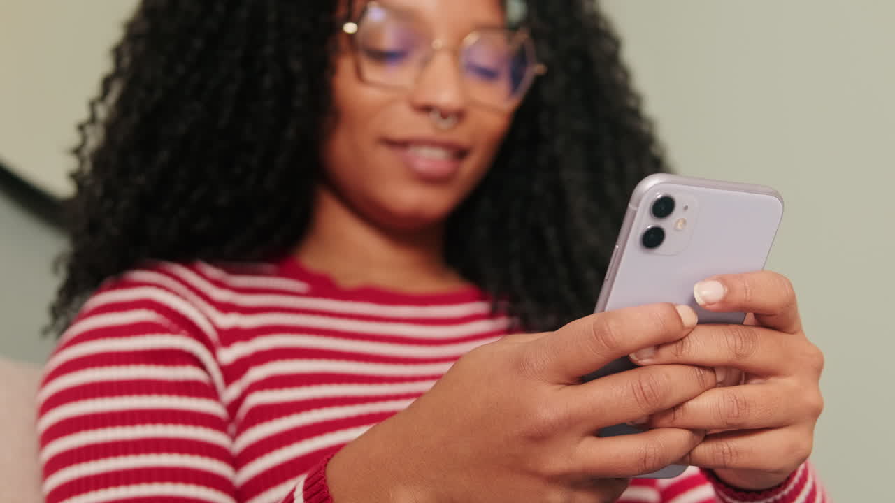 Giovane donna che messaggia e naviga sullo smartphone.
