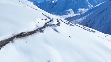 snowy mountain road with winding highway