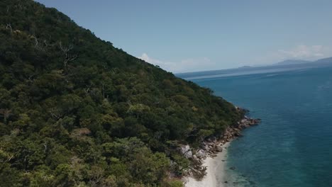 Drone-aerial-rising-and-revealing-tropical-white-sands-and-clear-blue-water-on-island