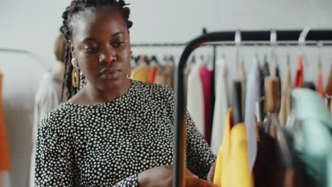 Young-African-American-Woman-Choosing-Clothes-in-Shop