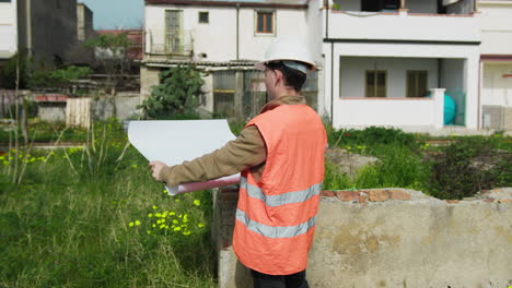 architect on the construction site while analyzing the project map