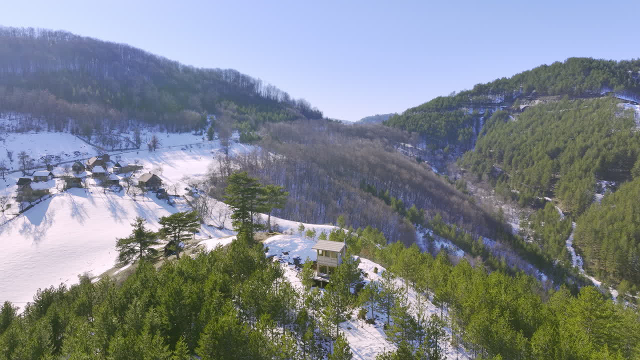 Aerial View of a Snowy Winter Mountain Village Landscape