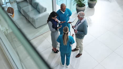 medical team meeting in hospital lobby