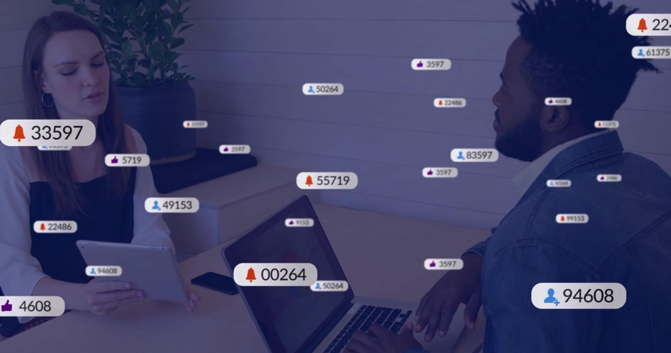 Woman using tablet, man typing on laptop, icon badges spreading then fading, showing work alerts