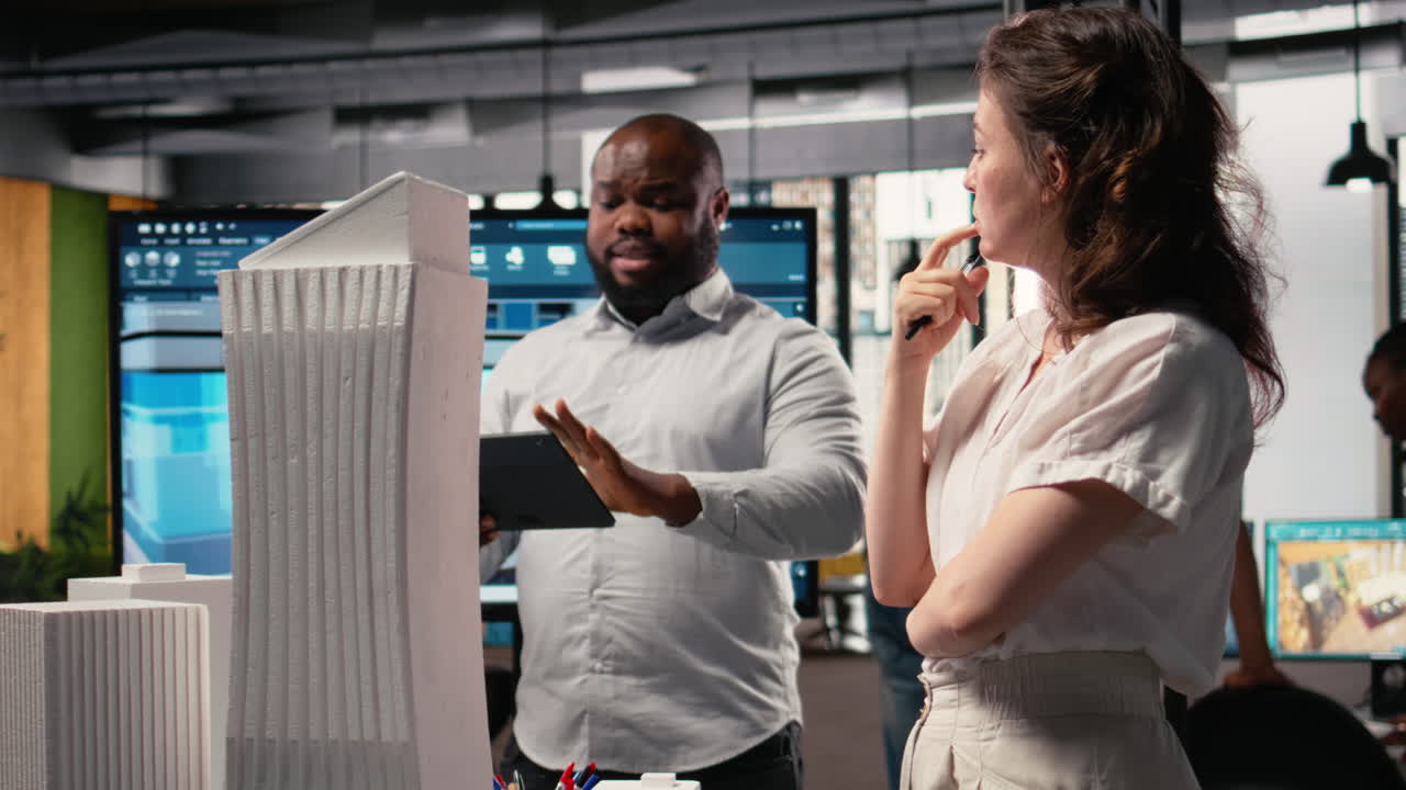 Property development team evaluating 3D models structural layout