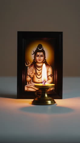 image of lord shiva with a lit diya