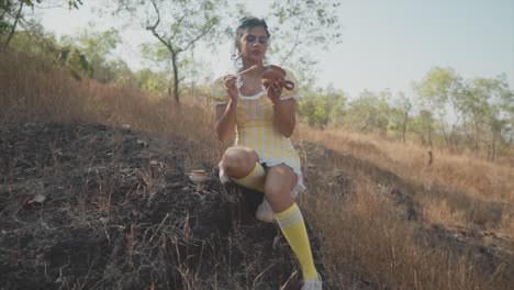 Dreamy-wide-slow-motion-shot-of-a-beautiful-indian-girl-in-a-yellow-dress-repairing-a-broken-piece-of-pottery