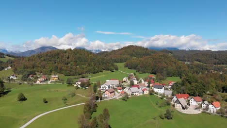 aerial view of mountain village prapetno brdo in slovenia, sunny summer day