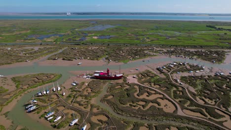 Trinity-Light-Ship-Moored-Among-Marshes-Of-Woodrolfe-Creek-Near-Tollesbury-In-Essex,-UK