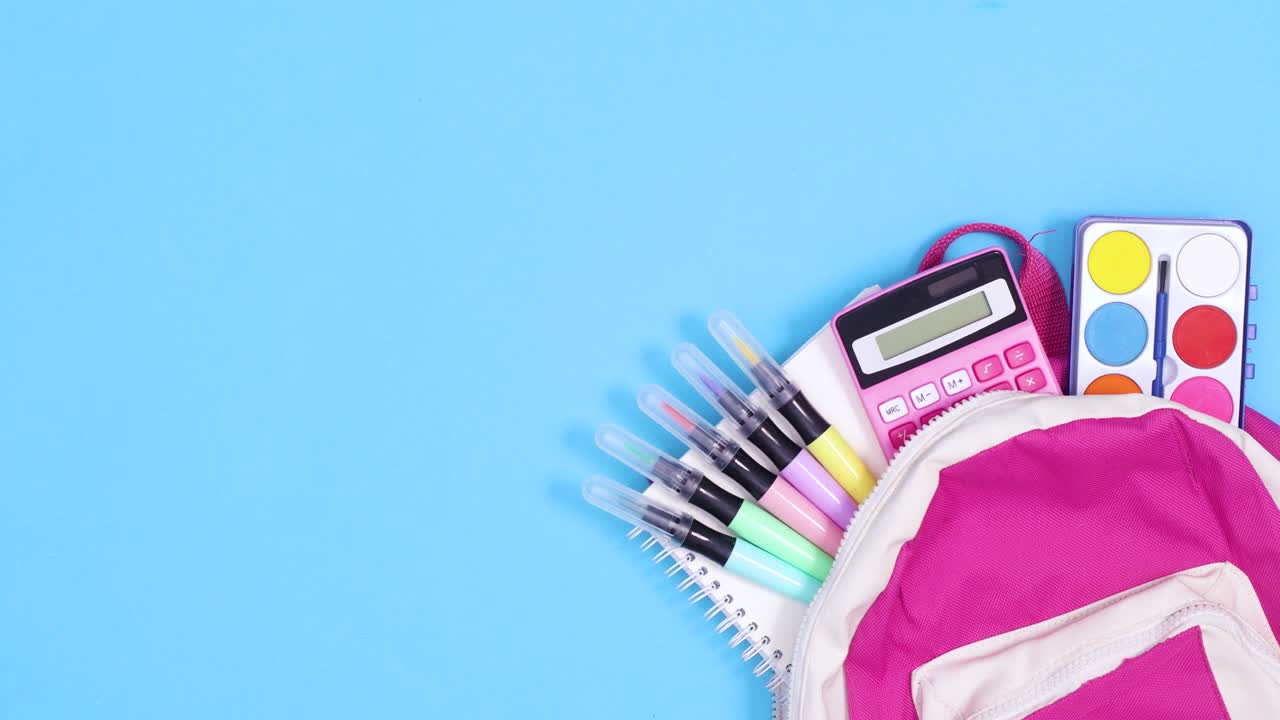 School backpack with school stationery move on blue background. Stop motion
