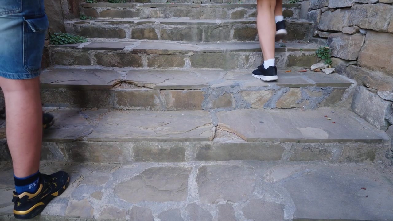 Old stone stairs leading through a historic medieval area of Veliko Tarnovo Bulgaria with weathered architectural surroundings