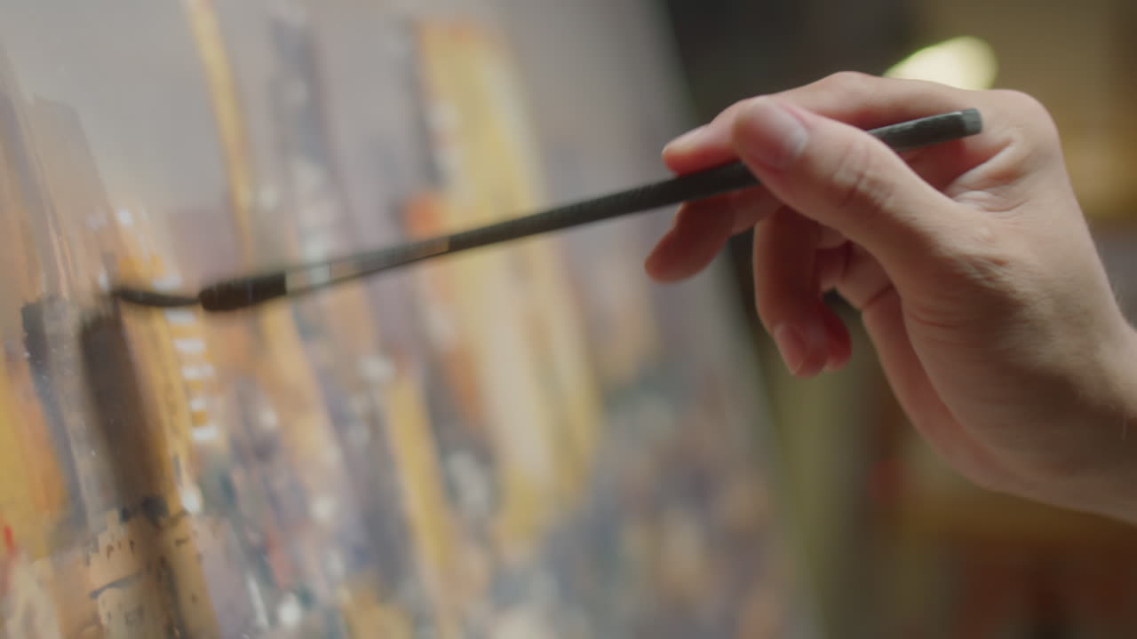 Hand of Artist Painting Picture on Canvas