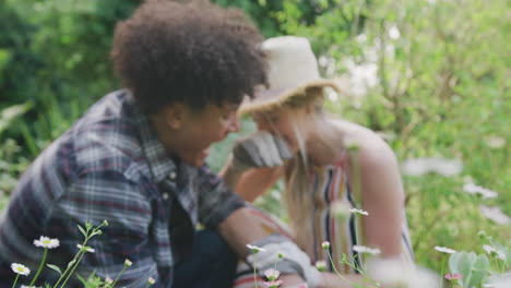 happy diverse couple working in garden on sunny day