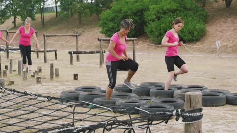 Female-friends-enjoying-exercising-at-boot-camp-together