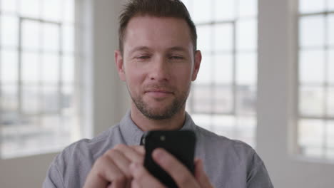 close-up-portrait-of-young-caucasian-man-texting-browsing-networking-using-smartphone-mobile-technology-start-up-business-apartment