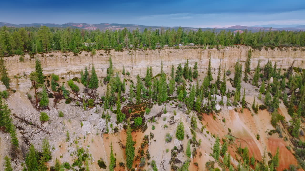 Delightful sight of beautiful cliffs overgrown with pine trees. Amazing mountains and blue skies at backdrop.