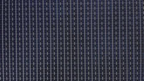 aerial view of floating solar panels in a small pond