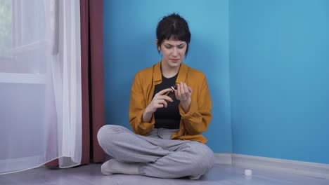 Suicide-young-woman-leaning-against-the-wall.