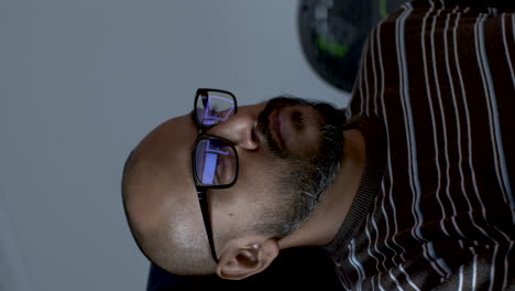 a middle-aged man is swaying in his chair